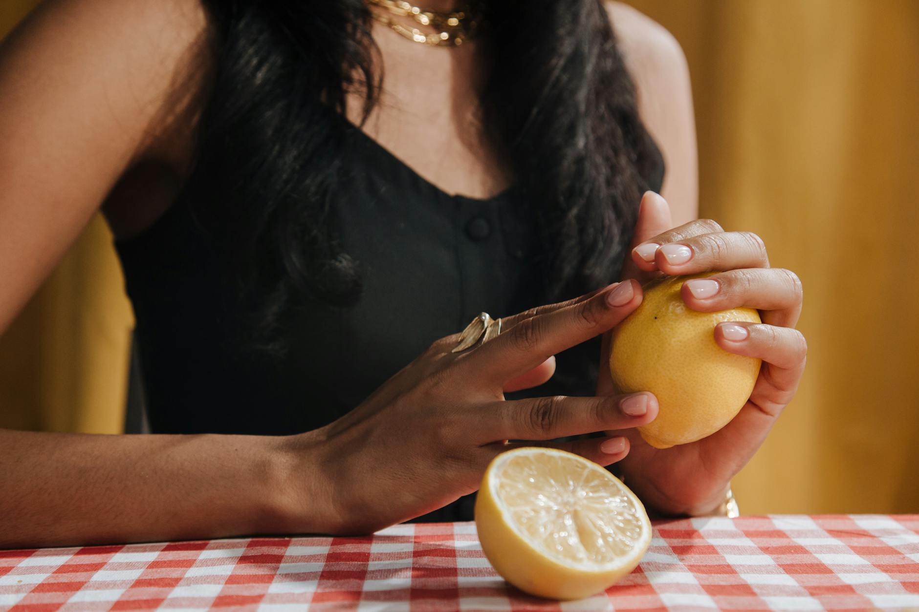 Woman holding a blue clitoral vibrator, showing the device up close