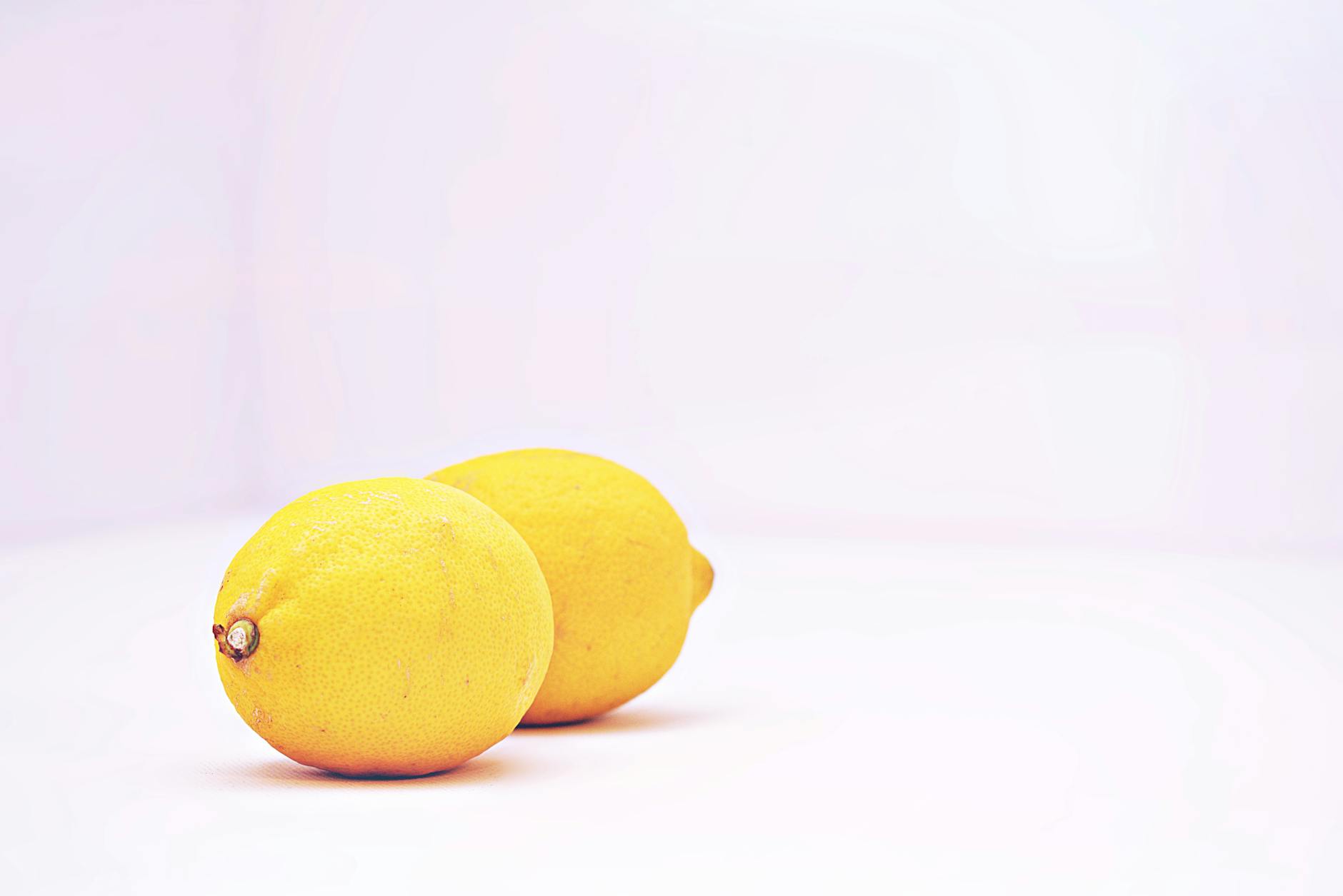 Two vibrant lemons on a white background, symbolizing fresh starts and reconnection
