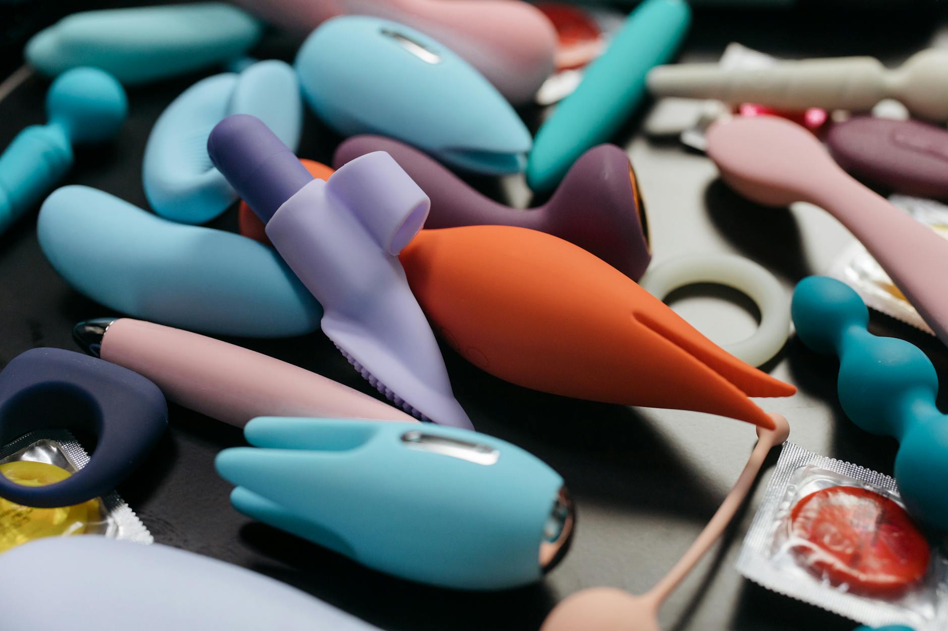 An array of vibrant clitoral vibrators and intimate wellness toys in a close-up view